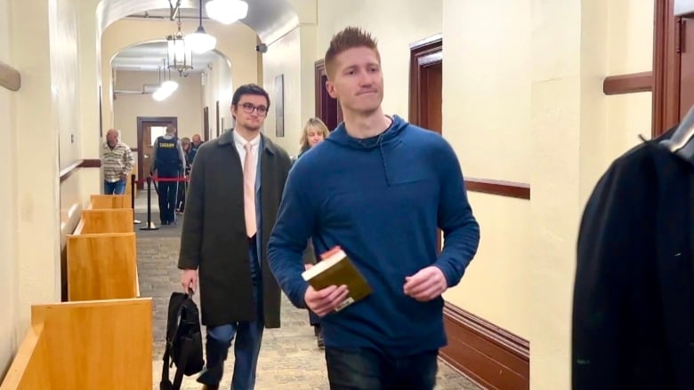 Matthew Day walks with his lawyers into the courtroom. 