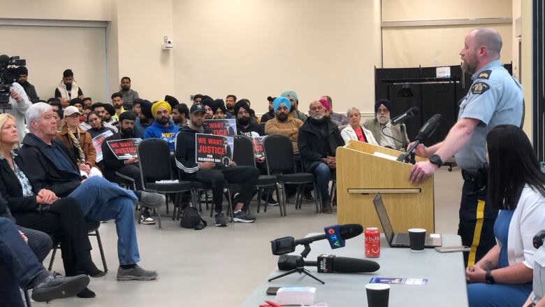 Photo of RCMP talking to community members at White Rock Community Centre.