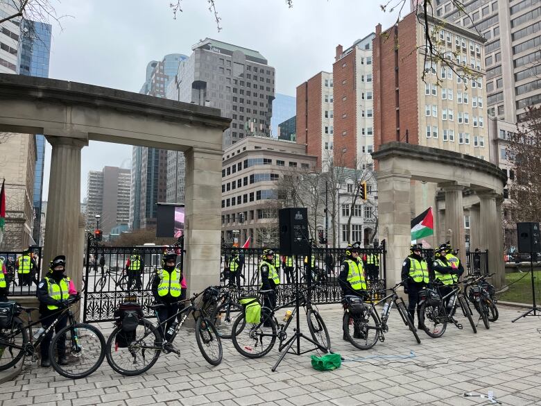 More than a dozen Montreal police officers surround McGill University's Roddick Gates.