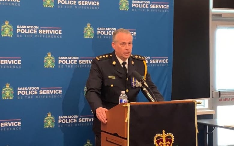 A police officer talking at a podium.