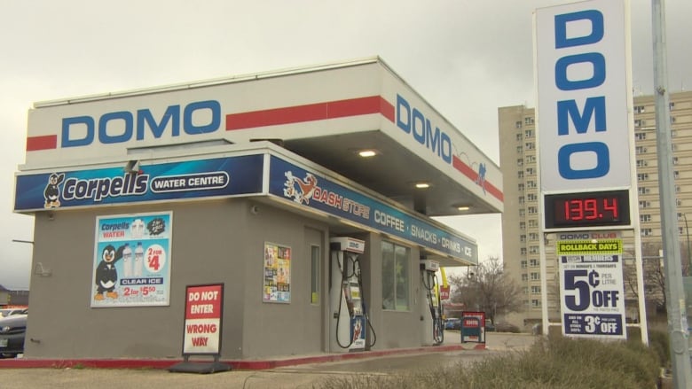 The exterior of a gas bar with white signage.