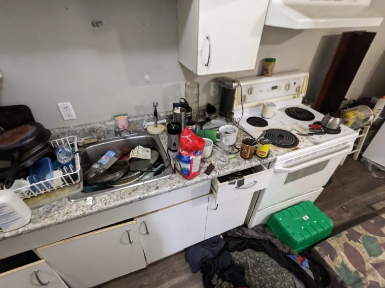 A kitchen counter full of dirty dishes.