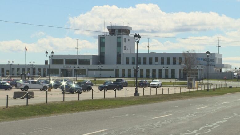 the exterior of an airport on a sunny day.