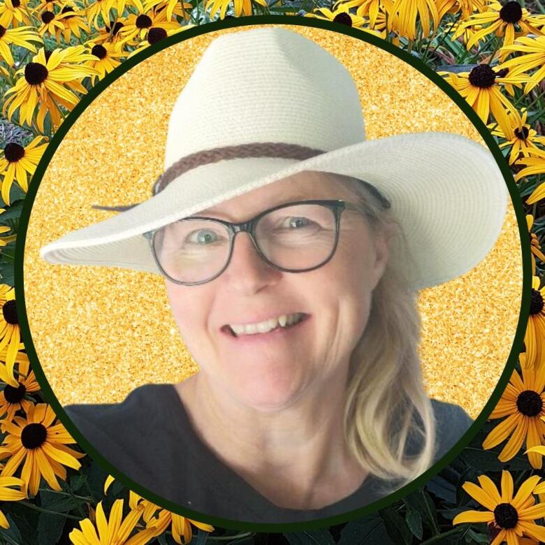 Smiling blonde lady with glasses in front of background of yellow daisy-like flowers with black eyes.