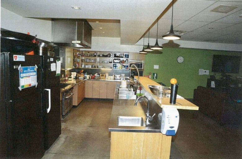 A kitchen in a large open room.