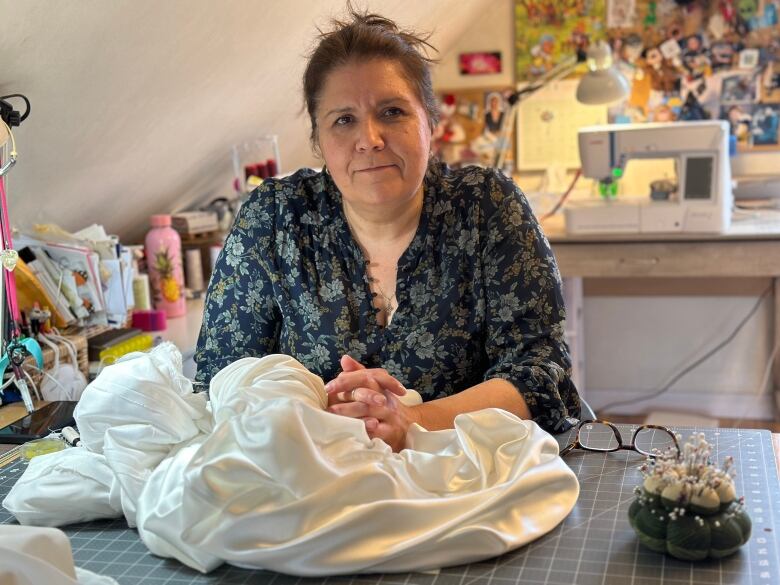 Woman with a dress at sewing table