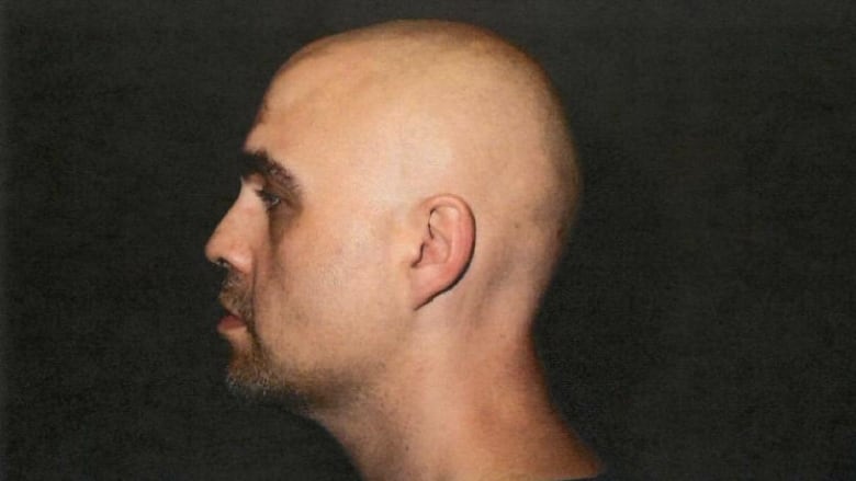 A side profile of a bald man.