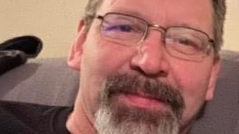 A man with glasses and a beard seen in a close up shot 