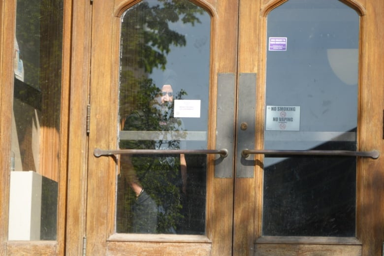 A security guard looks out the window