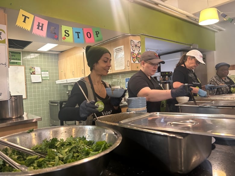 Volunteers prepare to serve food.