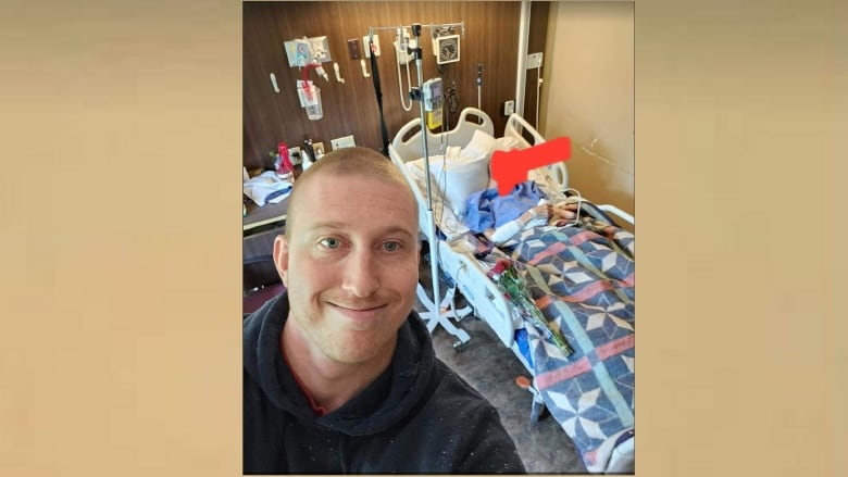 A selfie image of a smiling man in a hospital room.