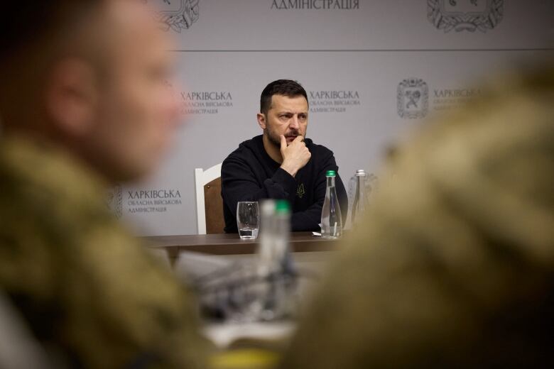 A handout photo from the Ukrainian Presidential Press Service shows Ukrainian President Volodymyr Zelenskyy attending a meeting with military officials in Ukraine's Kharkiv region on Thursday, May 16, 2024.