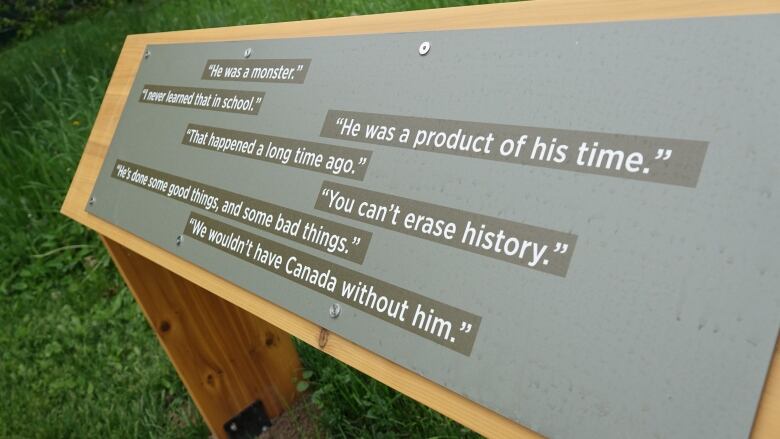 A plaque covered in quotes, some praising the country's first prime minister, while others dismiss him.