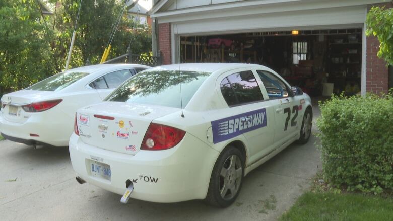 A white car with stickers and logos