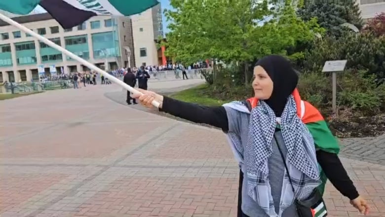 A woman waving a Palestinian flag