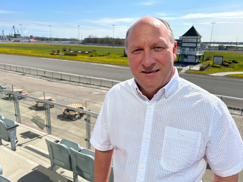 Man standing above race track.