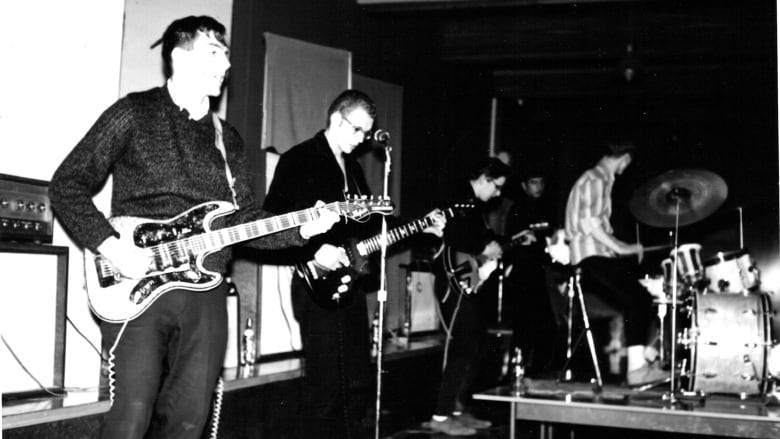 A black and white photo of a band playing music