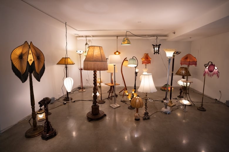 a collection of antique lamps of varying sizes