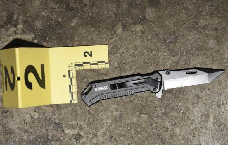 A knife beside an evidence marker. 