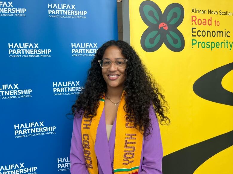 A young black woman smiles at the camera after speaking to reporters about her work on a youth council for African Nova Scotian economic prosperity.