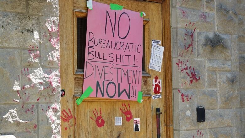 A pink poster reading 