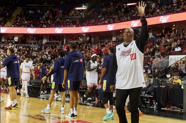 A man waves to a crowd of people