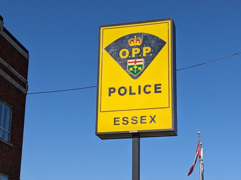 A yellow OPP sign set against a blue sky.