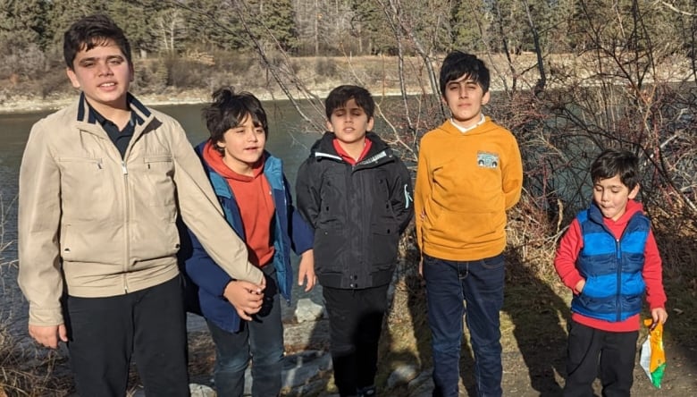 Samiullah Ashna's five children are pictured in a Calgary park. 