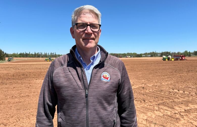 Man stands in a potato field.