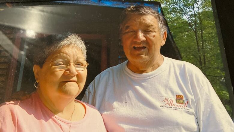 Two people posing for a portrait dating back a couple of decades.