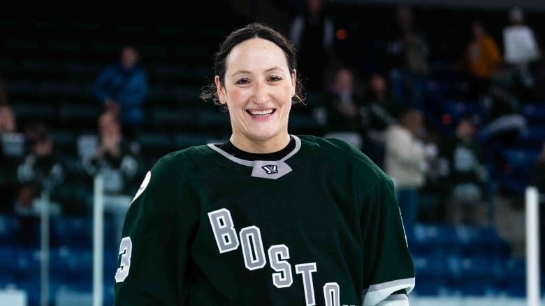 smiling woman in Boston jersey 