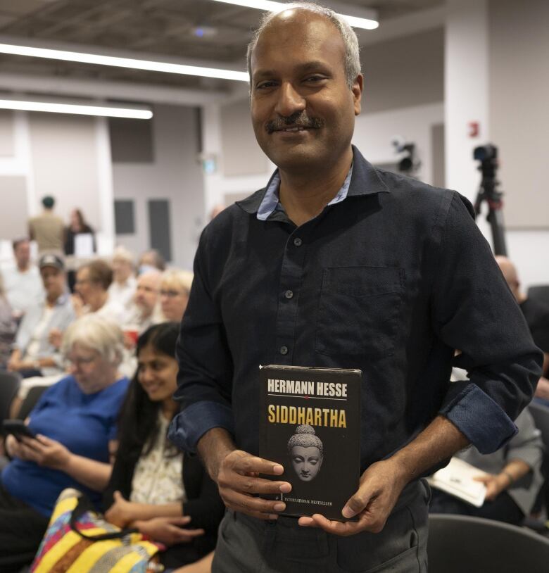 Ravi Selvaganapathy holds a copy of Siddhartha by Herman Hesse.