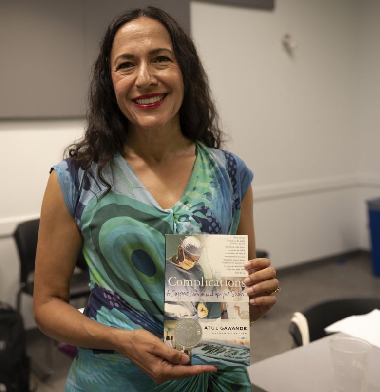 Sheila Singh holds a copy of Complications by Atul Gawande.