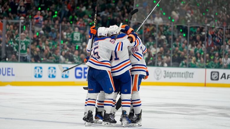 A group of hockey players celebrate together.