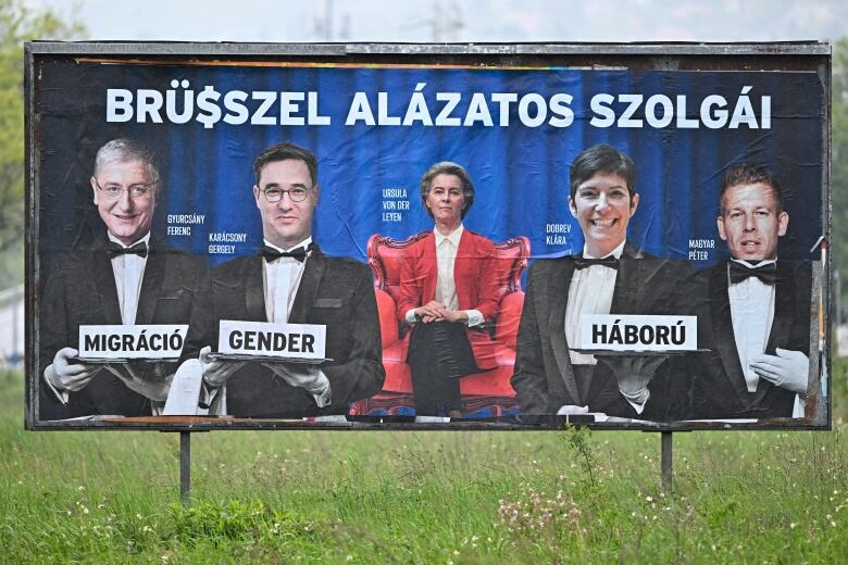 A billboard shows a woman in a red chair flanked by four men wearing waiter's clothing. 