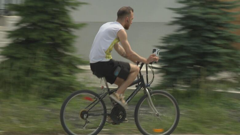 A cyclist uses the sidewalk along Wyandotte Street East near Pillette. 