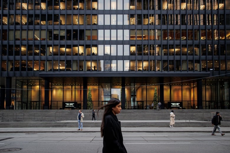 A woman walks through Toronto's downtown.