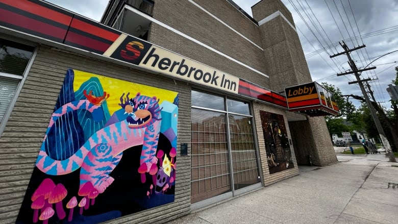 A brightly colours painting on a brick building wall.