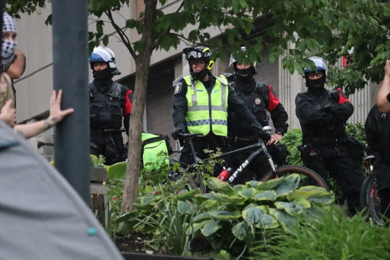 police with bikes and protesters