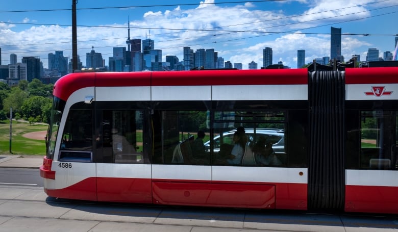 A Toronto Transit Commission streetcar drives past the downtown skyline in Toronto on Thursday June 6, 2024.  TTC workers will be in a position to strike at midnight on June 6. THE CANADIAN PRESS/Frank Gunn