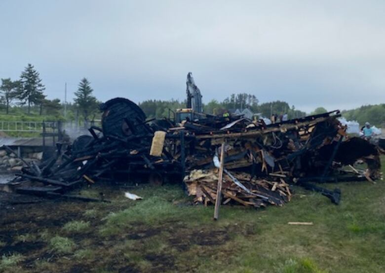 A photo shows rubble of a sawmill museum.