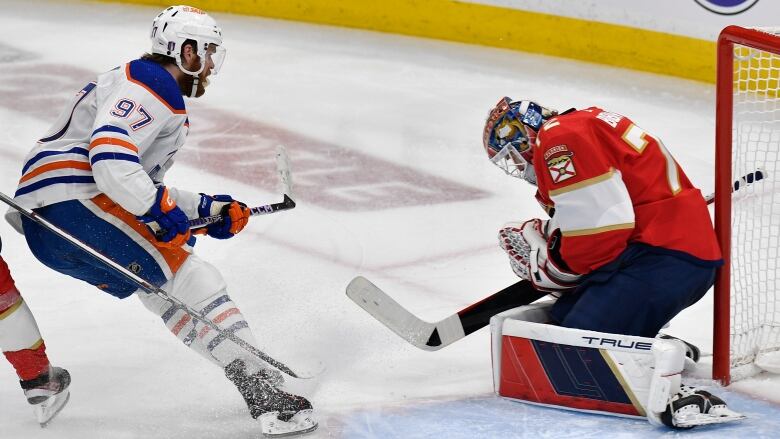 A hockey goalie stops a shot.