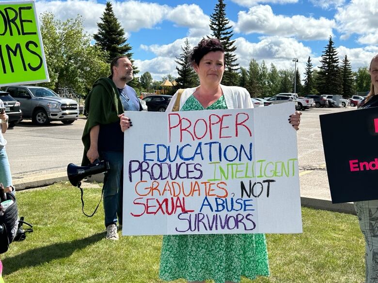 Former students of Legacy Christian Academy in Saskatoon and other protestors gathered outside Mile Two Church on Sunday.