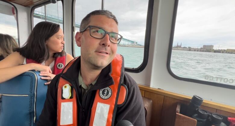 man in life vest wearing glasses