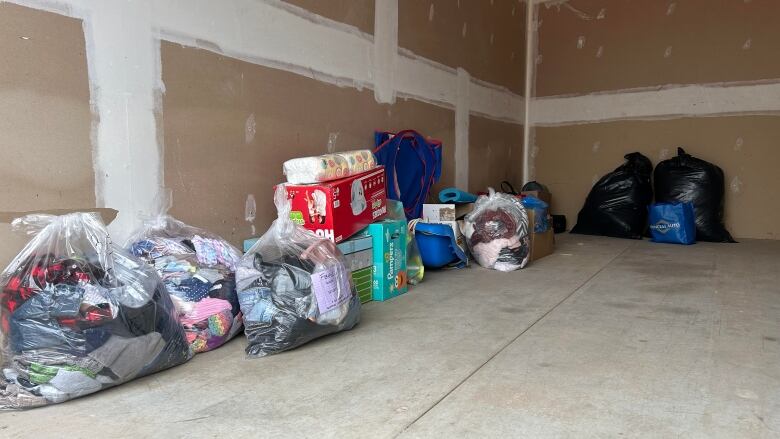 A storage container with items lined up along one wall.