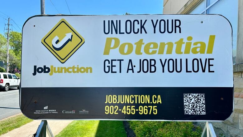 A billboard advertises an employment support program.