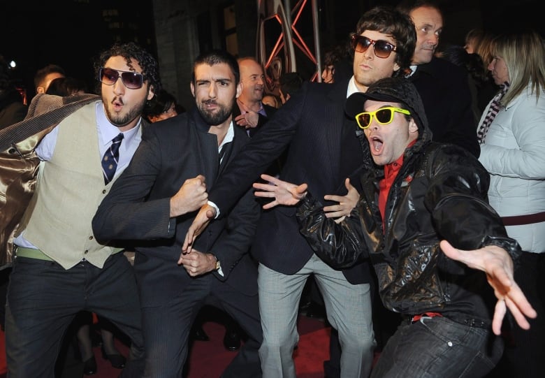 The four members of Radio Radio ham it up for the cameras as they arrive at at ADISQ, the Quebec music industry awards in Montreal on Nov. 2, 2008.