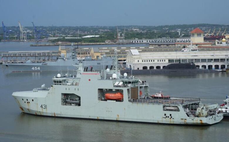 Canadian navy patrol boat HMCS Margaret Brooke passes by Russian nuclear-powered cruise missile submarine Kazan and frigate Admiral Gorshkov, as it enters Havana's bay, Cuba, June 14, 2024. 