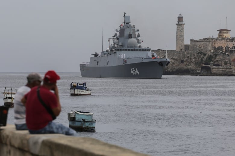 People watch the Russian Navy Admiral Gorshkov frigate arrive at the port of Havana, Cuba, Wednesday, June 12, 2024. A fleet of Russian warshipsreached Cuban waters on Wednesday ahead of planned military exercises in the Caribbean.