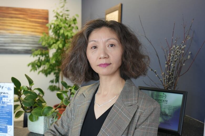 A woman poses in an office. 